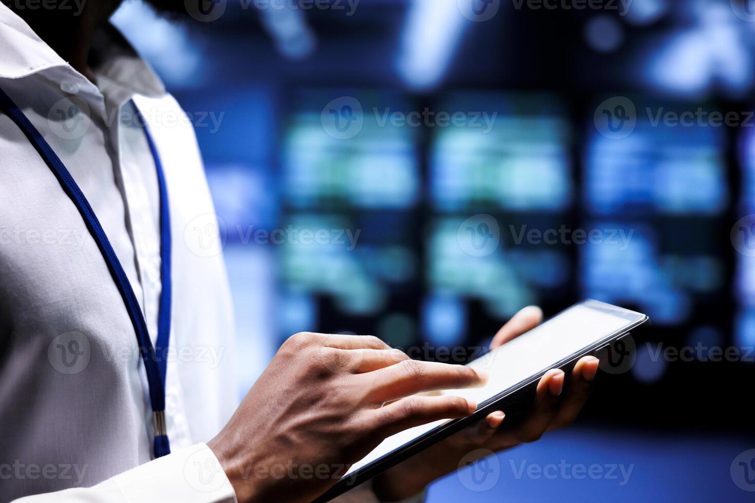 Specialist using mock up tablet to check server rigs doing intense computations. Technician preventing strain on data center infrastructure caused by AI applications driving up power usage photo