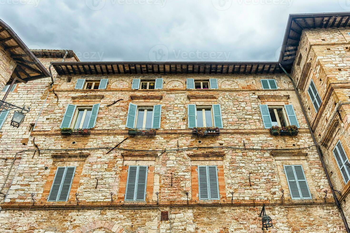 Historical buildings in the old city center of Assisi, Italy photo