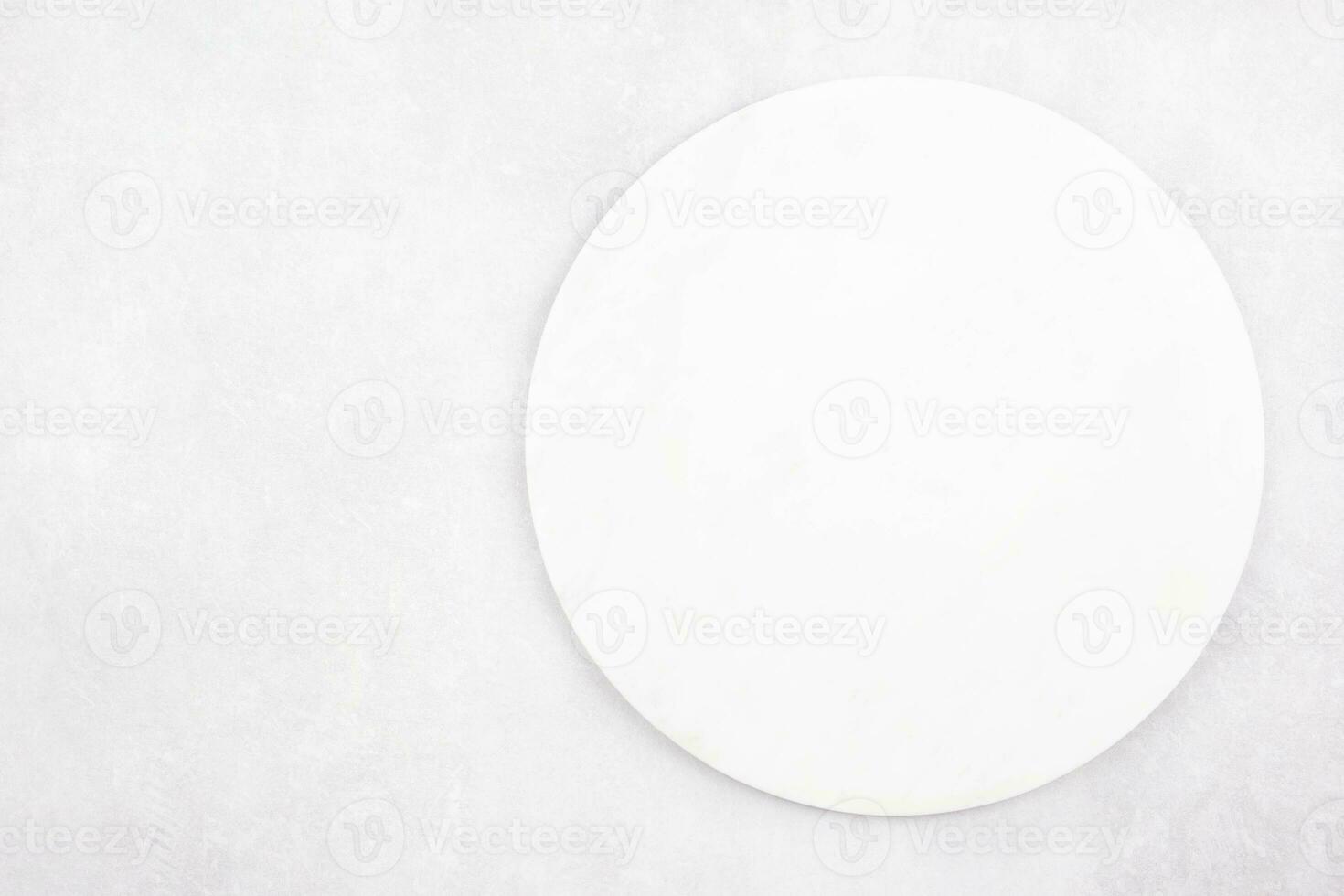 Marble round cutting board flat lay mockup on gray concrete stone background. Top view. Copy space. photo