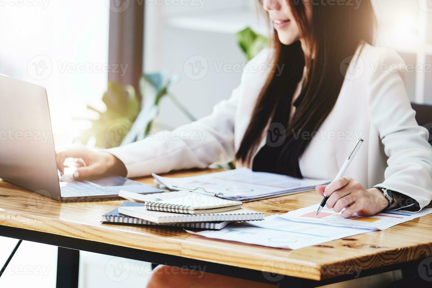 Investment concepts, businesswomen use document and computers to analyze stock markets, quantitative data collection, financial statement analysis, profitability through internet technology. photo