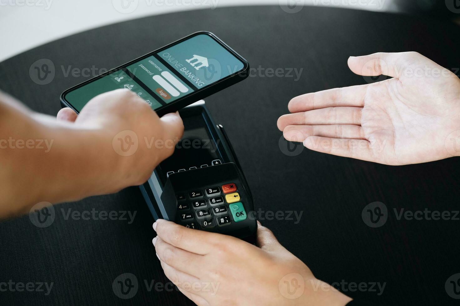 Payment security technology concept and service fees, Employees are holding electronic card machines for customers to use smartphone mobile to pay via paywave technology. photo