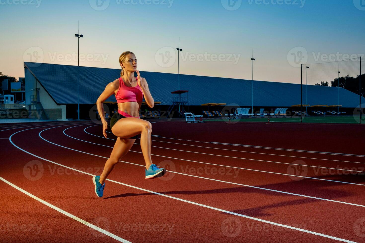 Runner sprinting towards success on run path running athletic track. Goal achievement concept. photo