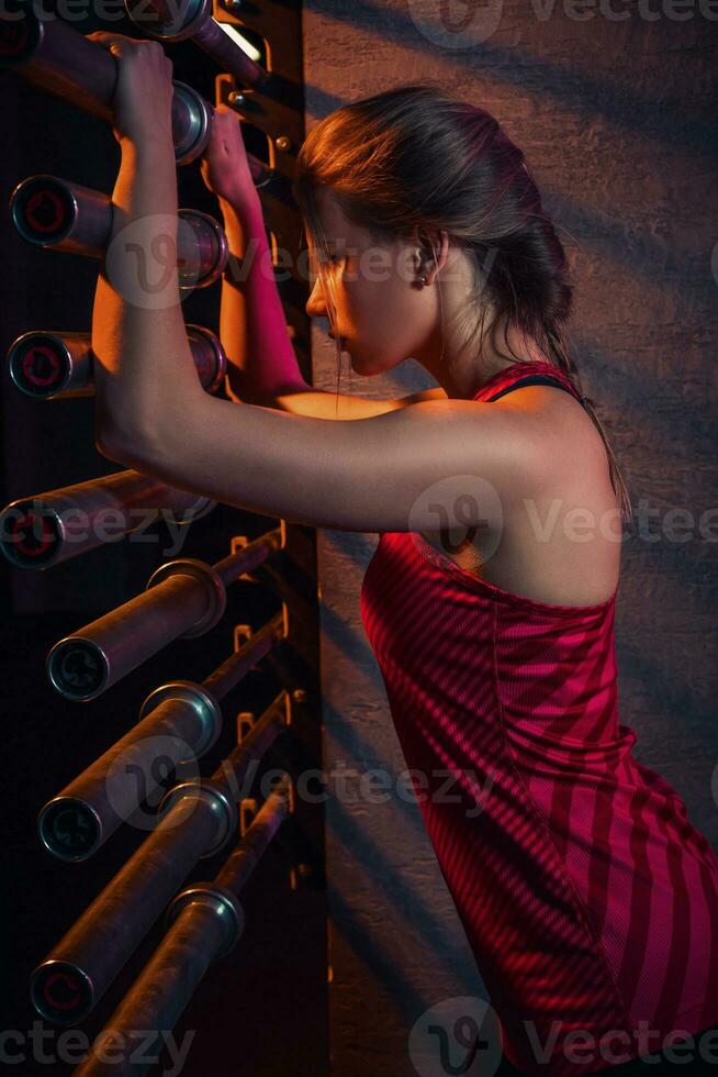 Young beautiful woman posing in a gym outfit. photo