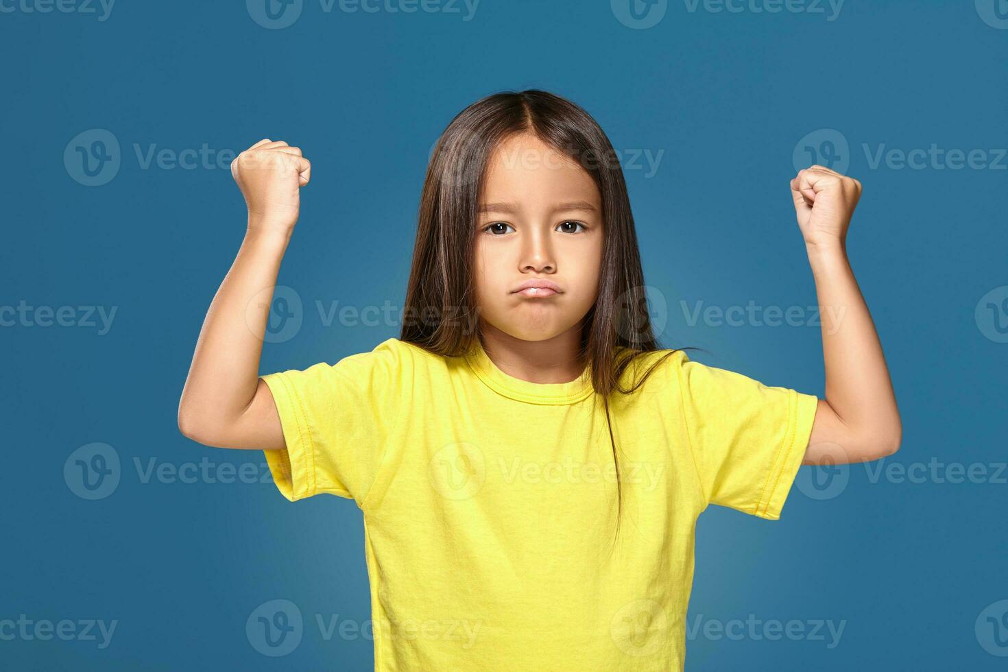 Angry little kid showing frustration and disagreement photo