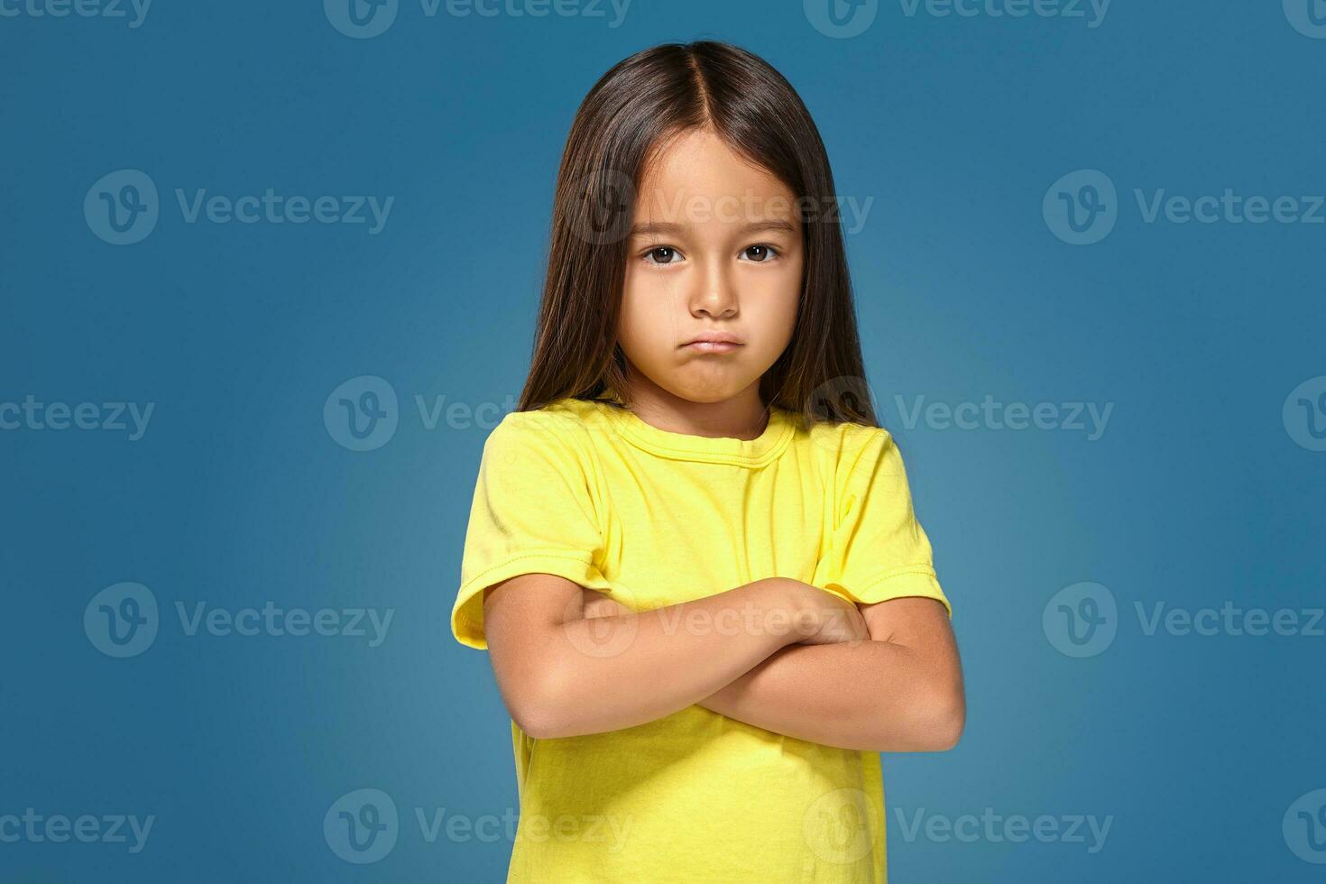 Angry little kid showing frustration and disagreement photo