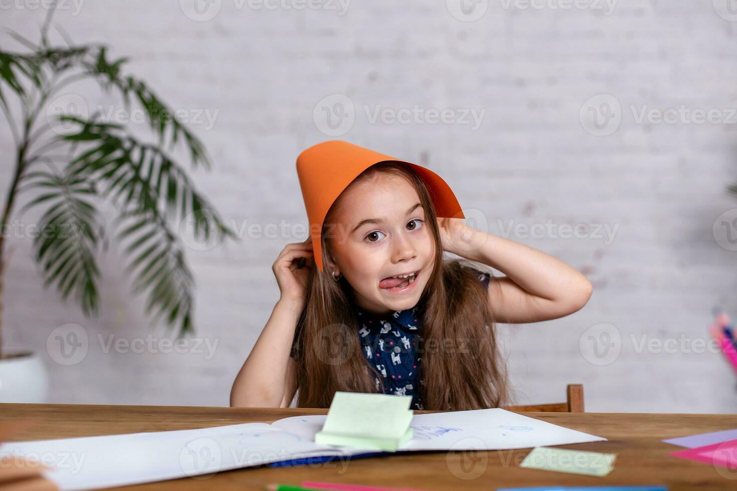 Cute little girl with the colored paper photo