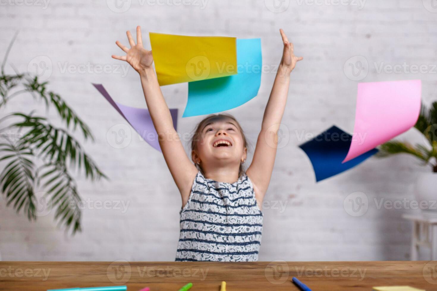 Cute little girl with the colored paper photo