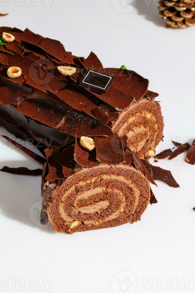 Sliced Swiss roll with buttercream, chocolate shavings and hazelnuts photo