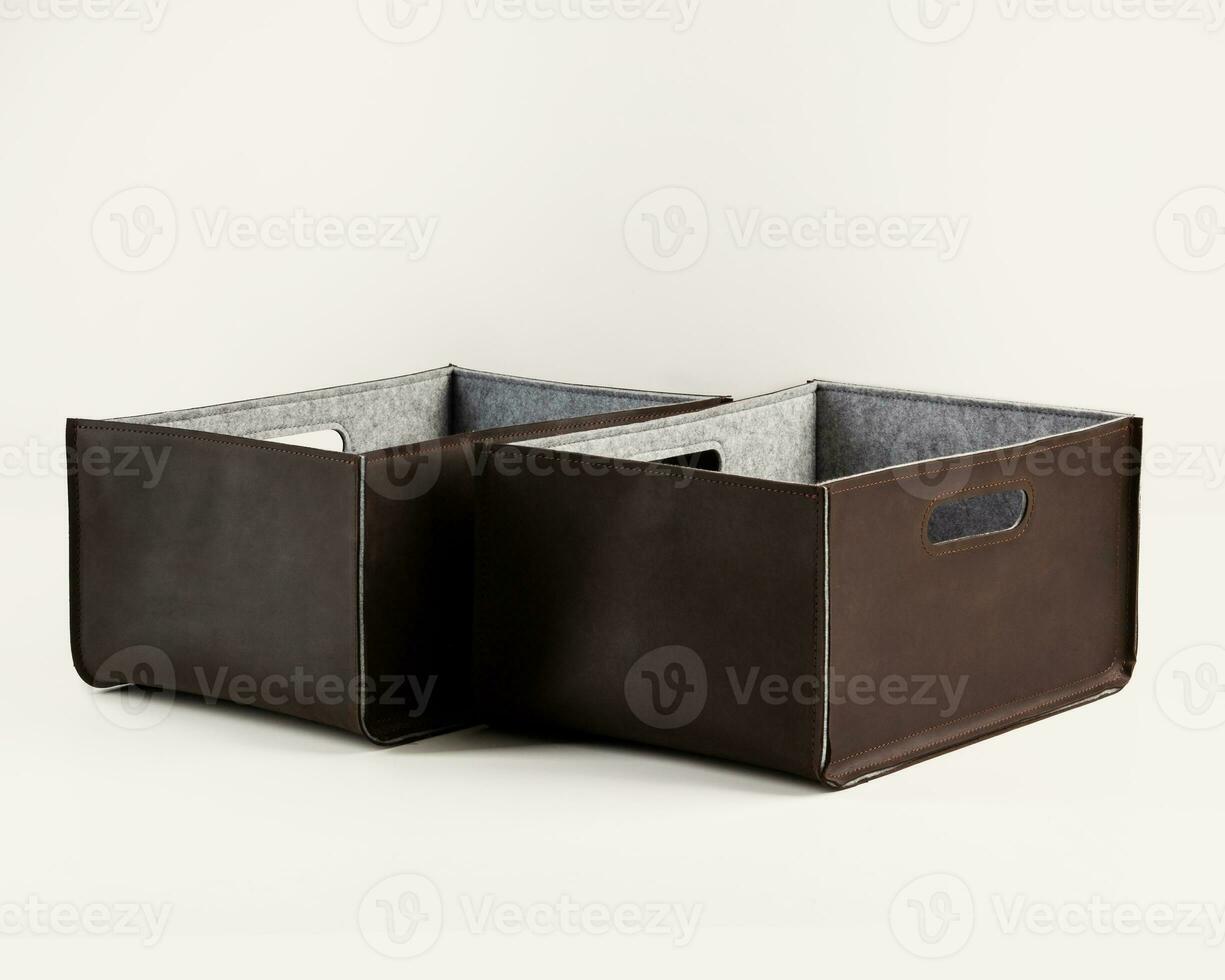 Two handcrafted brown faux leather storage boxes photo