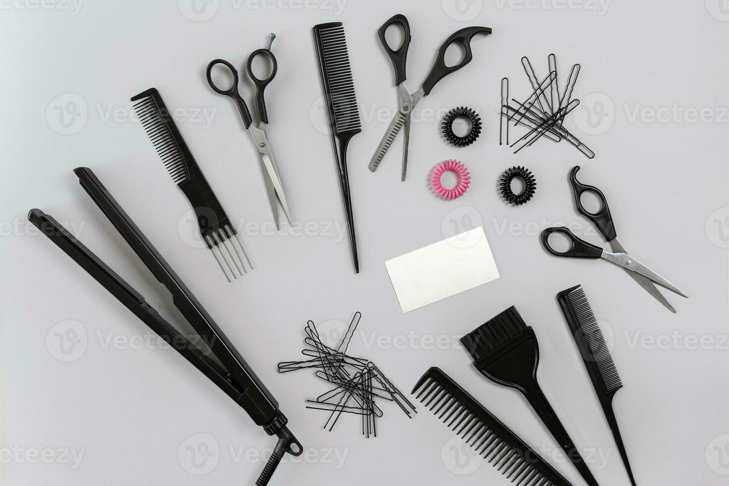 Hairdresser set with various accessories on gray background photo