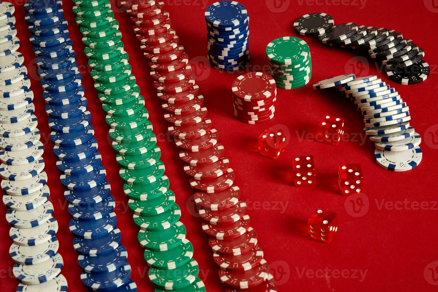 Stack of poker chips on red background at casino photo