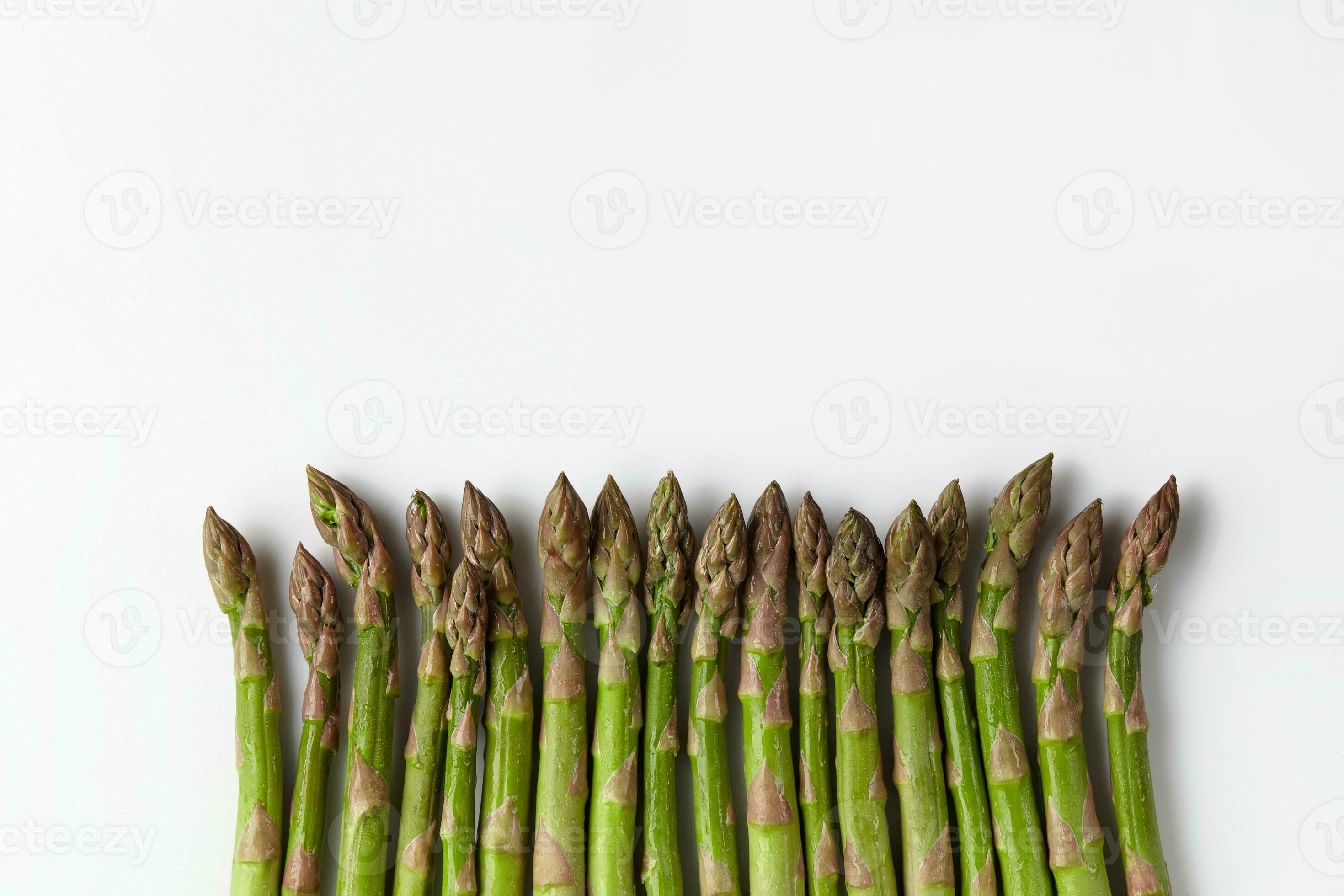 Green fresh asparagus stems isolated on white background. Healthy