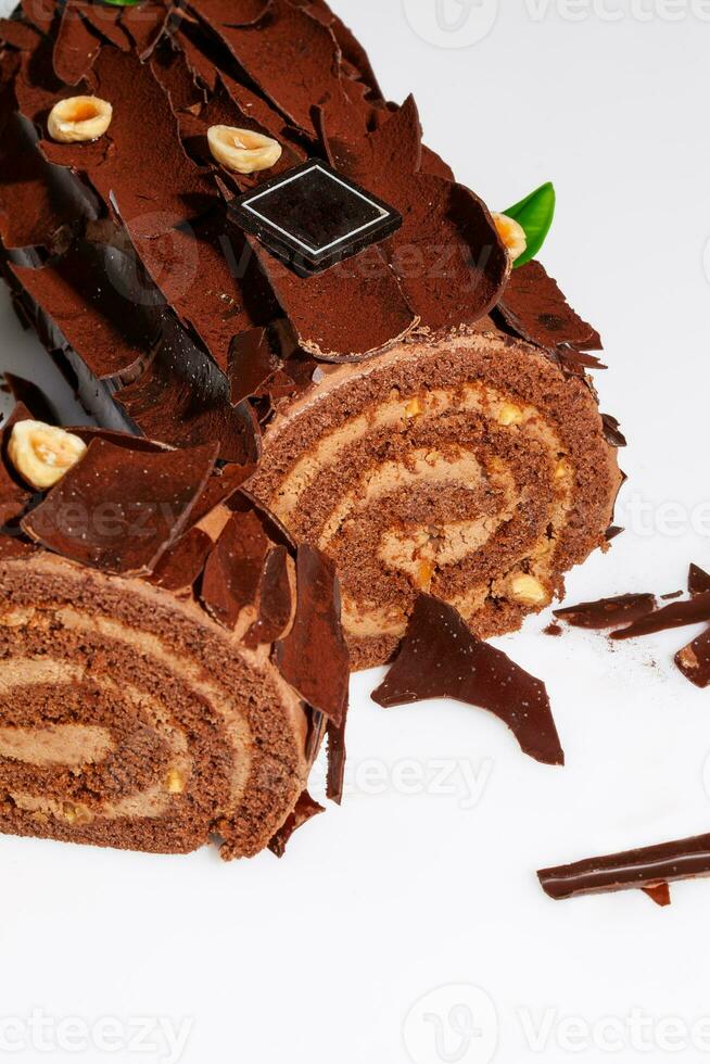 Sliced Swiss roll with buttercream, chocolate shavings and hazelnuts photo