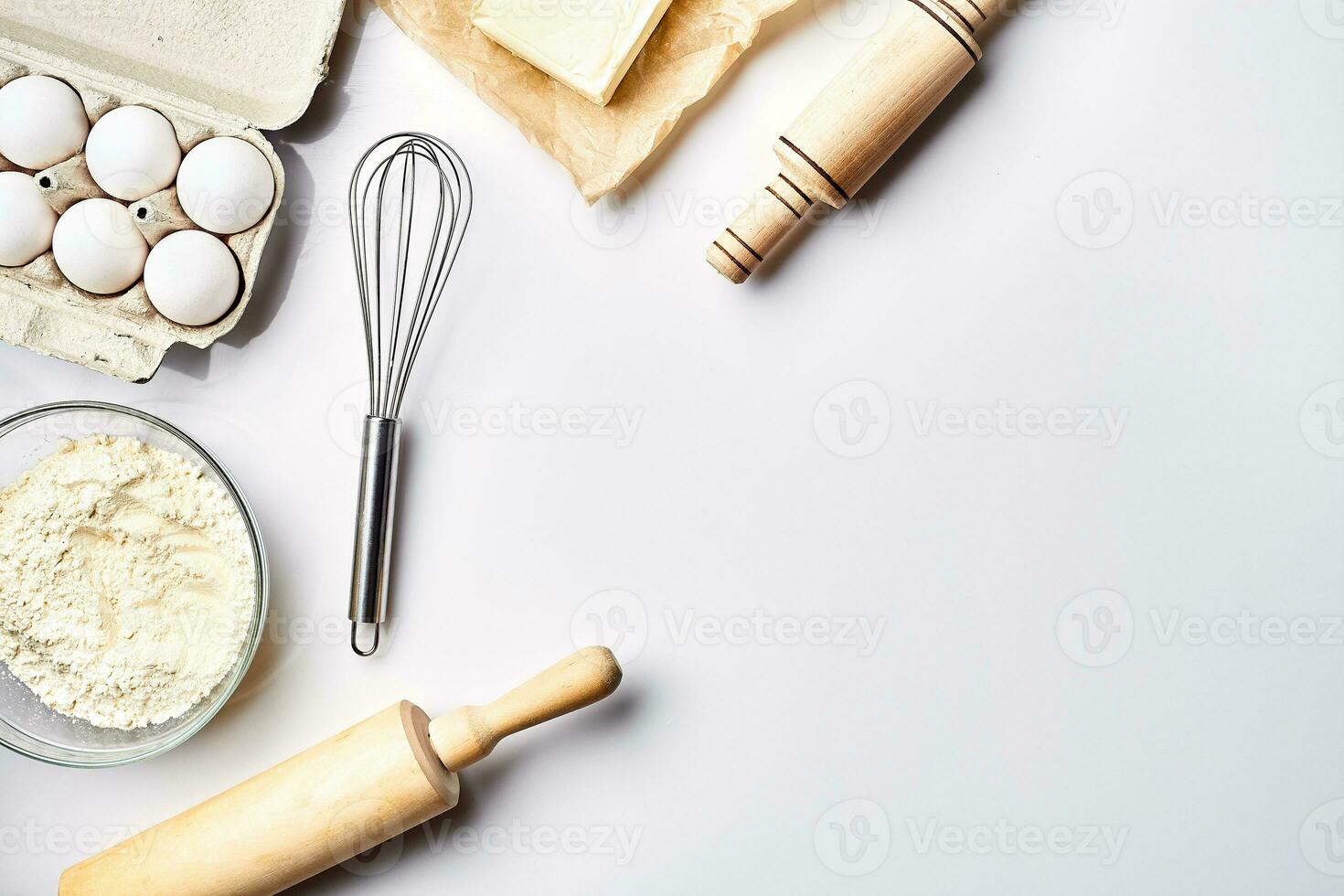 Preparation of the dough. Ingredients for the dough - flour, butter, eggs and various tools. On white background. Free space for text . Top view photo