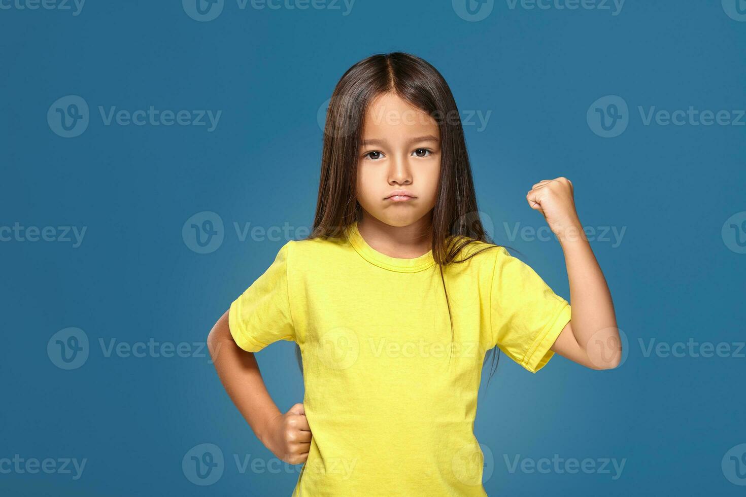 Angry little kid showing frustration and disagreement photo