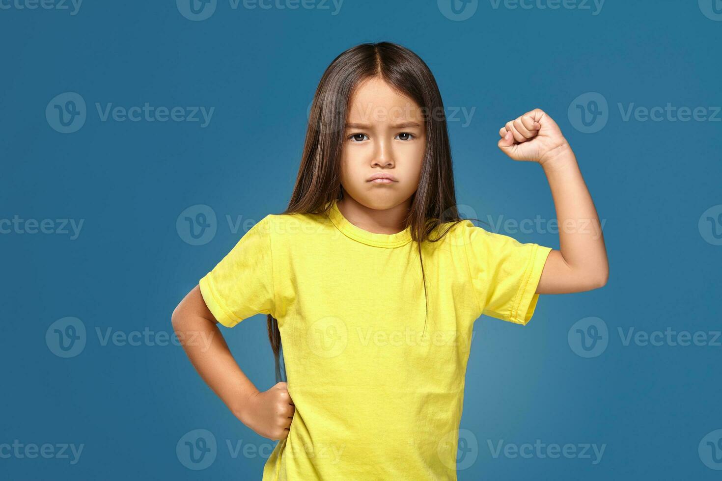 Angry little kid showing frustration and disagreement photo