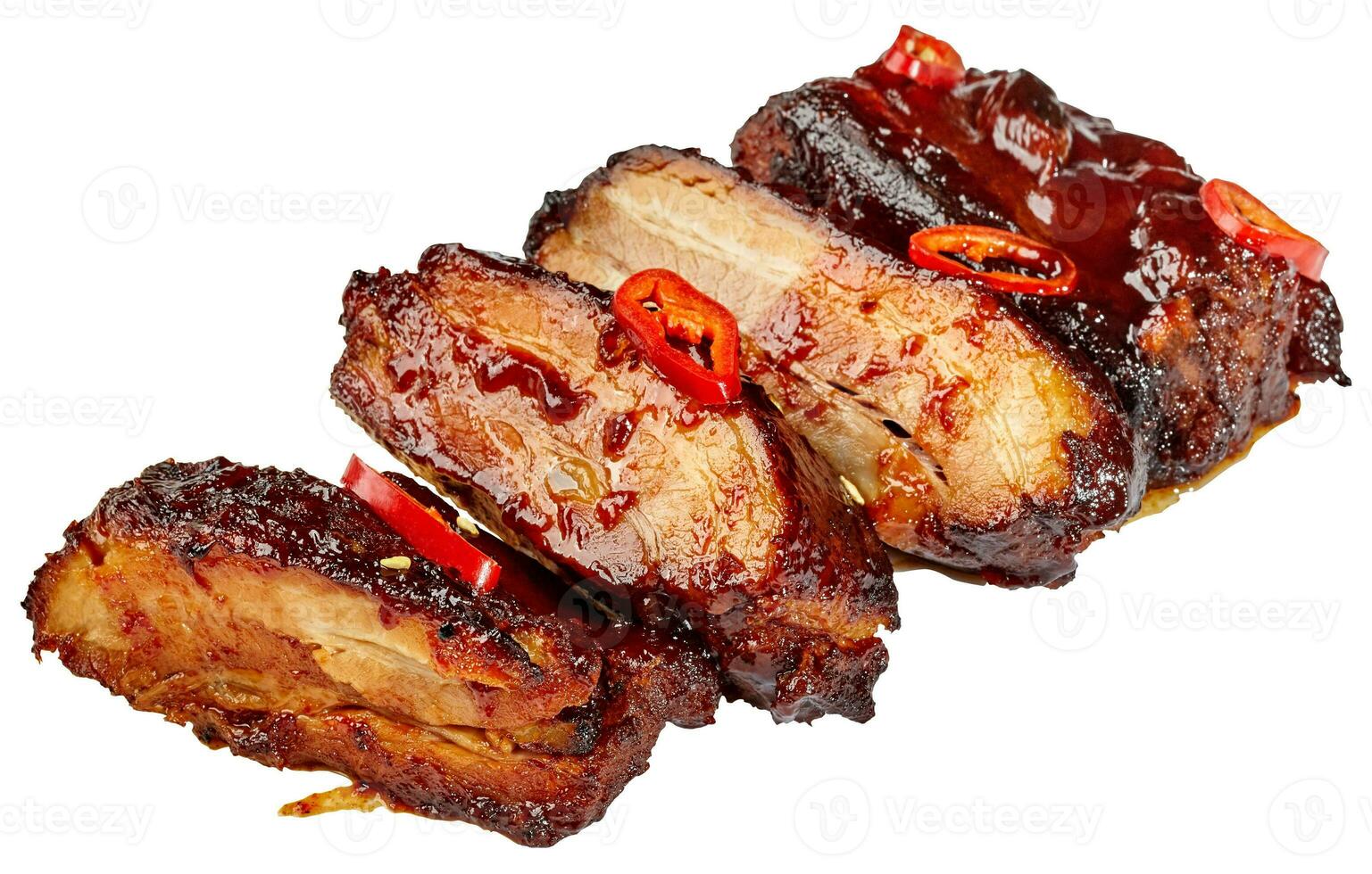 Sliced baked pork ribs in barbecue sauce with chili pepper isolated on white photo