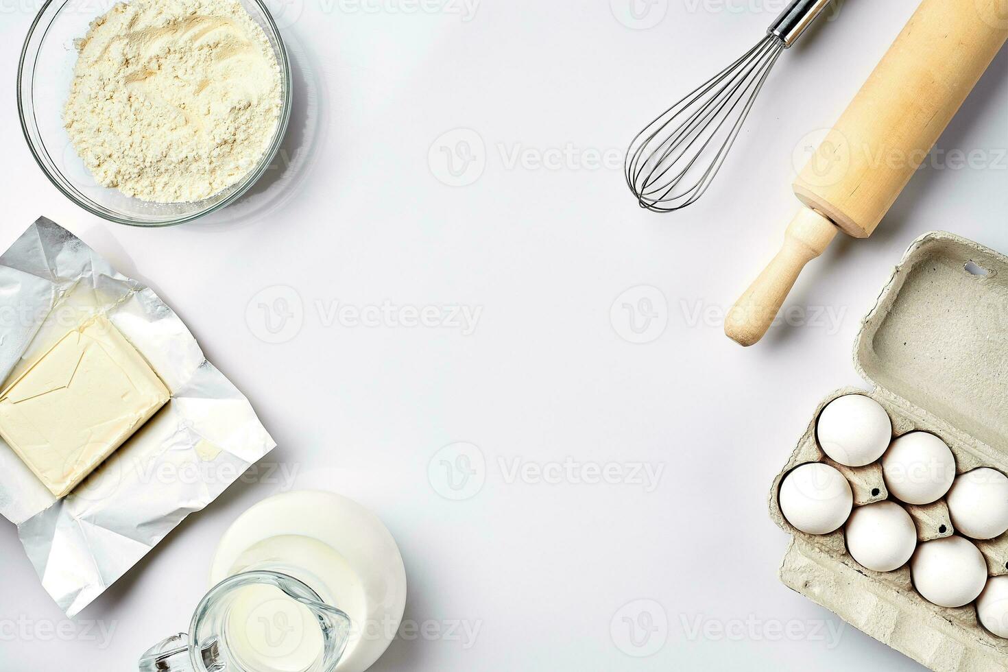 Preparation of the dough. Ingredients for the dough - flour, butter, eggs and various tools. On white background. Free space for text . Top view photo