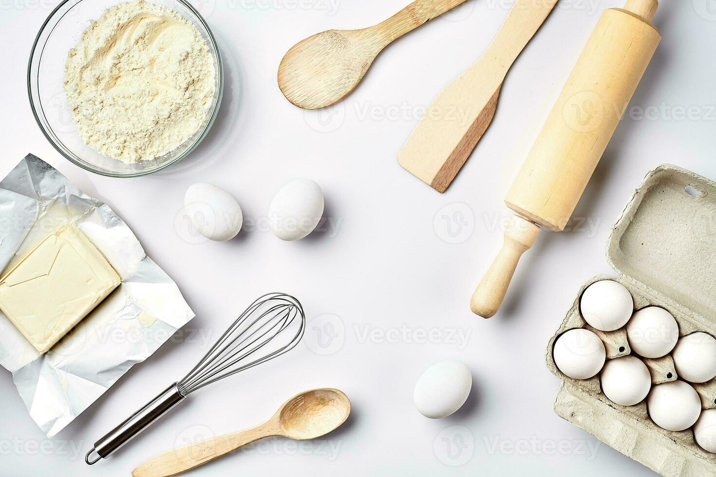 Preparation of the dough. Ingredients for the dough - flour, butter, eggs and various tools. On white background. Free space for text . Top view photo