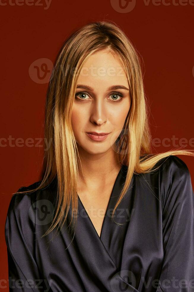 Seductive close up portrait of beautiful blonde young woman in cocktail dress photo