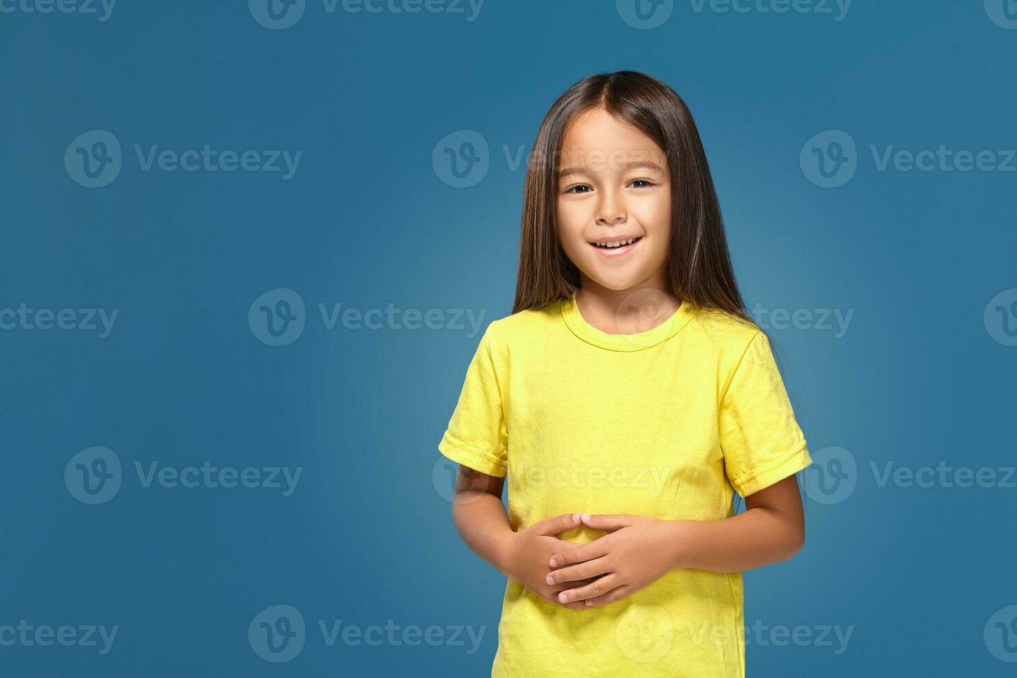 Little girl in yellow t-shirt is smiling photo