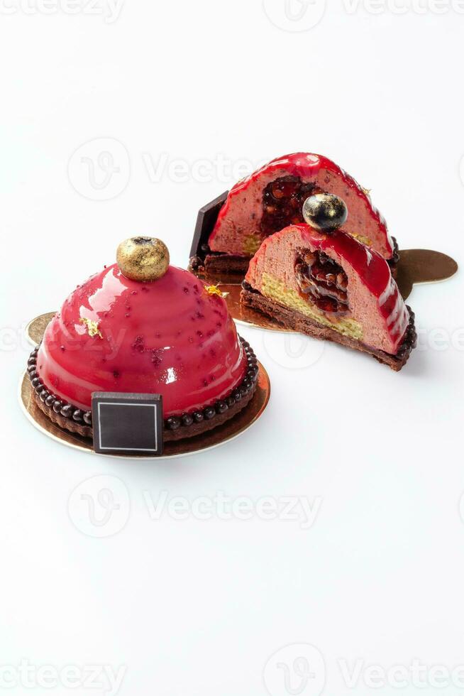 Dessert of airy plum mousse on chocolate shortcrust base with fruit filling and glaze photo