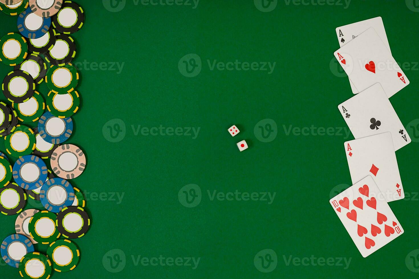 different color chips for gamblings and playing cards on green photo