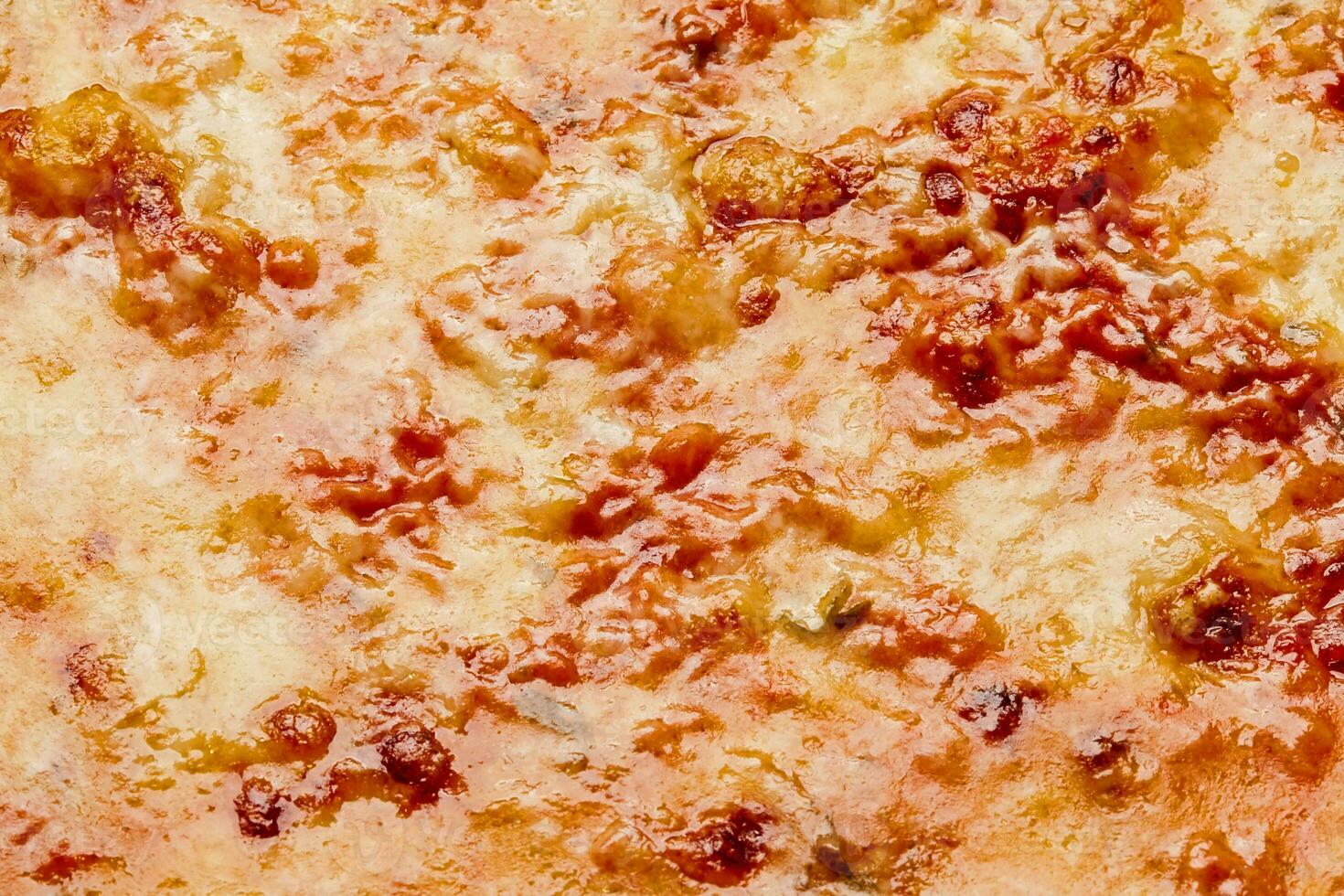 Closeup of browned cheese crust on pizza bolognese with mincemeat and tomato sauce photo