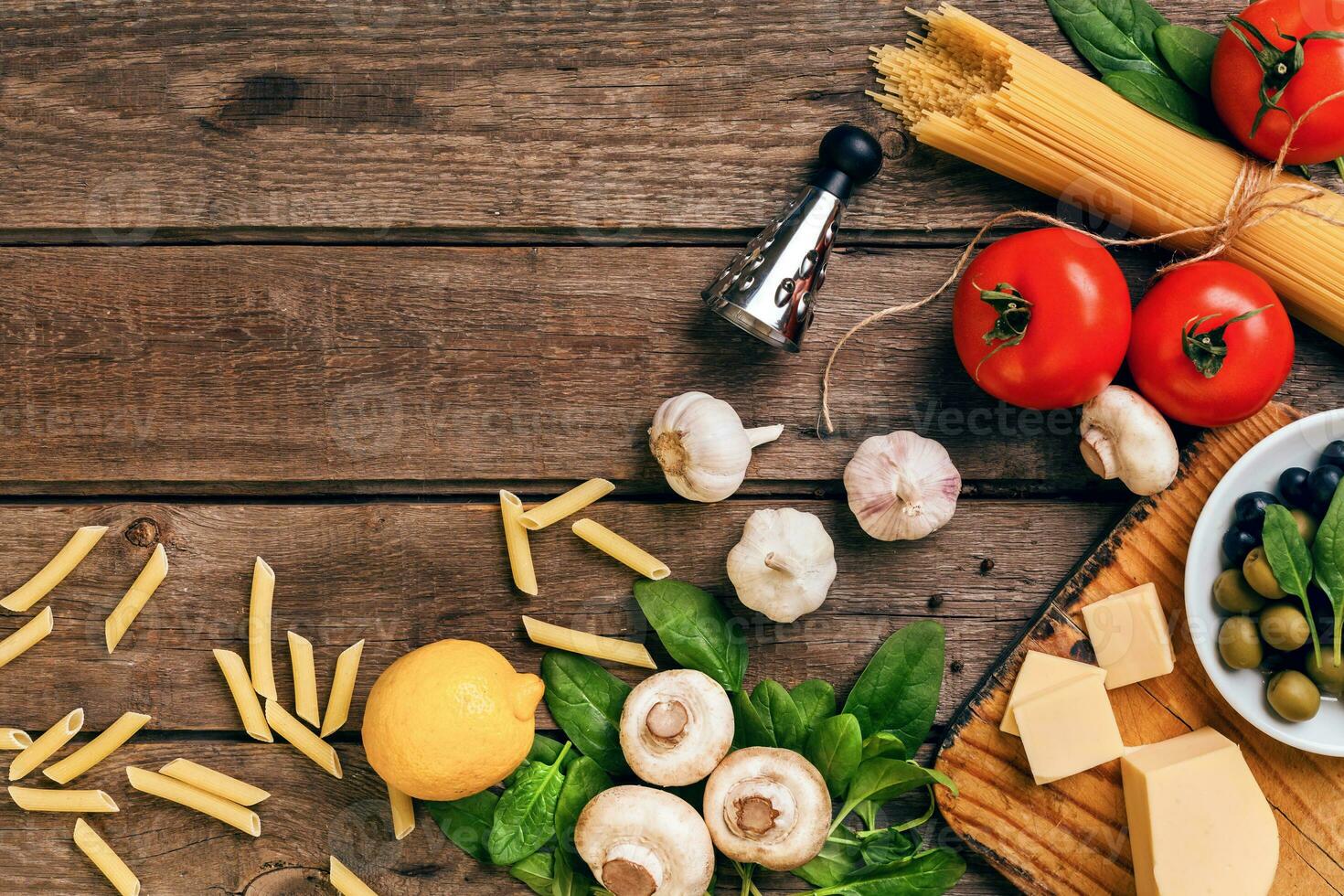 Italian food background with pasta, spices and vegetables. Top view, copy space. photo