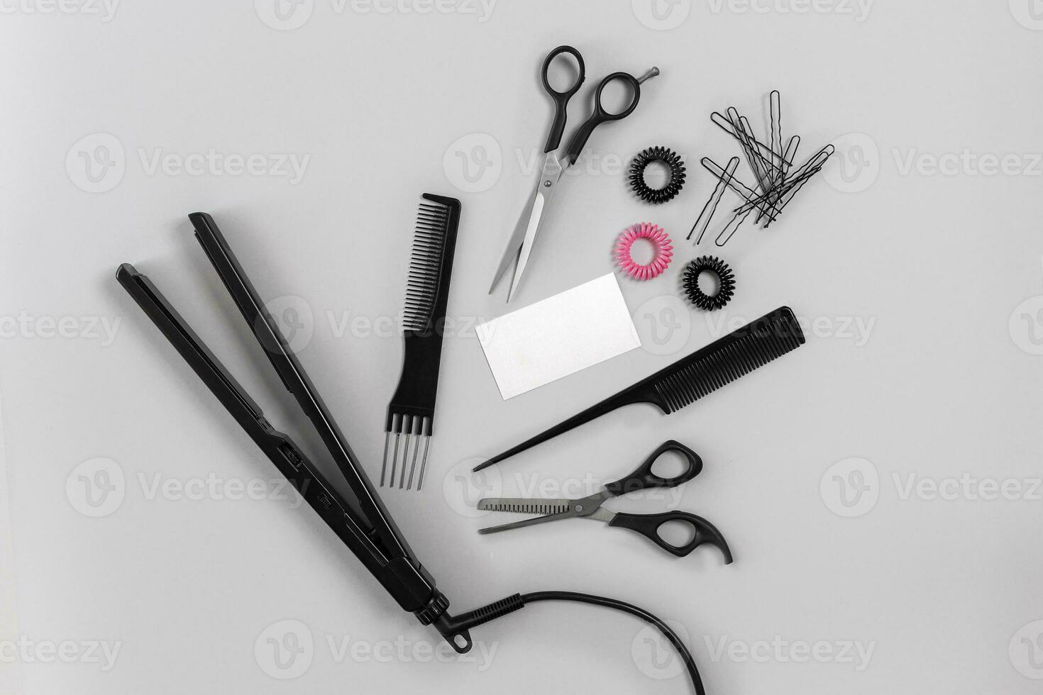 Hairdresser set with various accessories on gray background photo