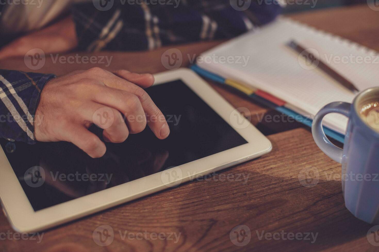 Man using tablet works. White tablet with blank screen in a man photo