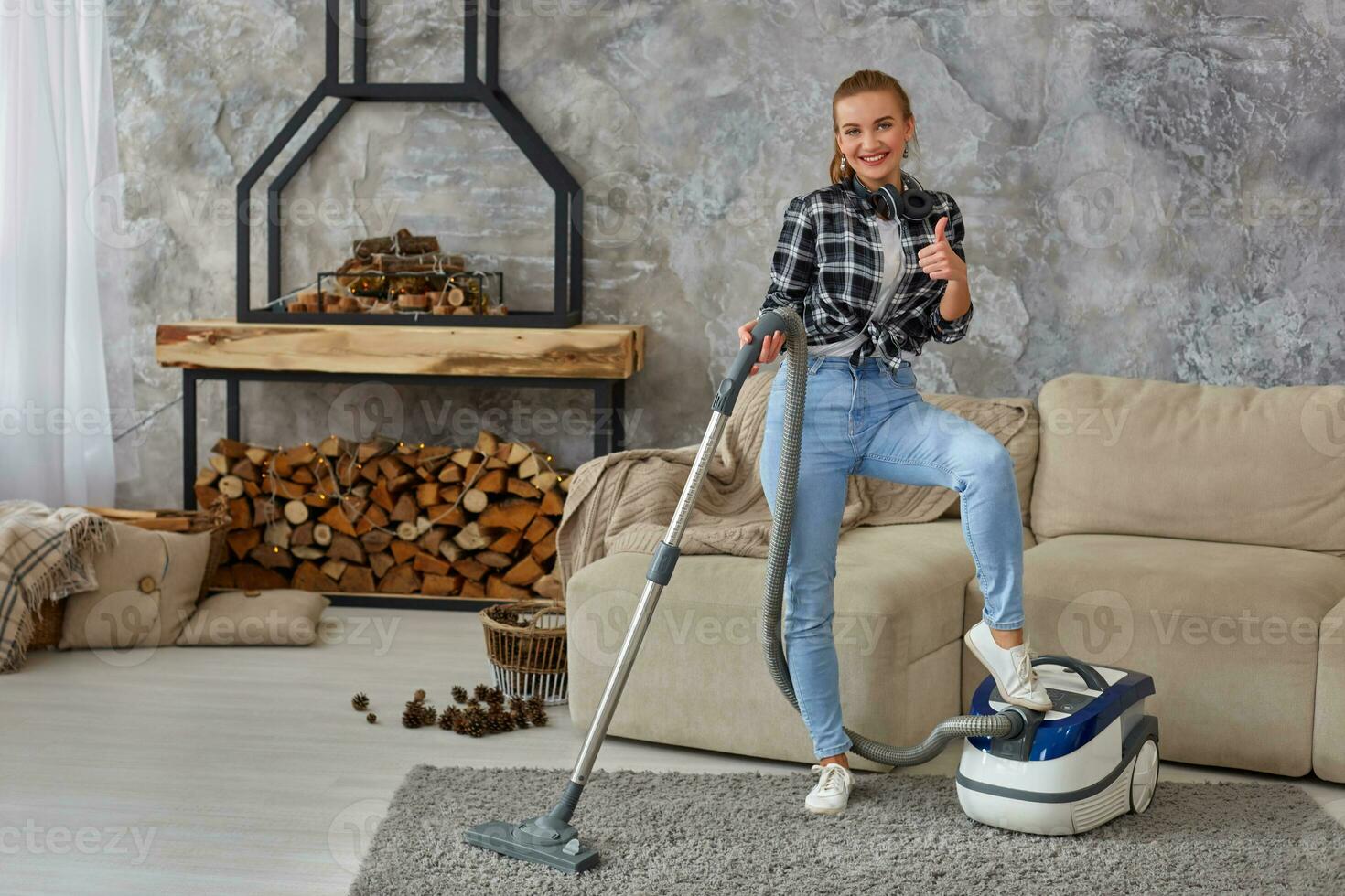 Slim woman cleaning with vacuum cleaner carpet photo