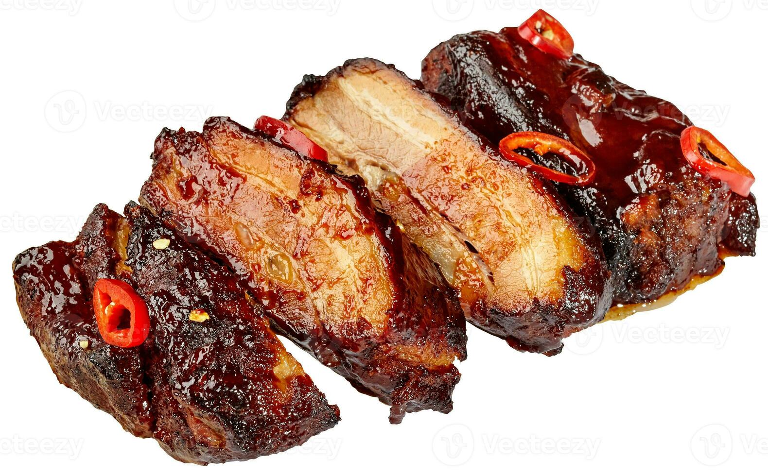 Slices of grilled pork ribs in barbecue sauce with chili peppers on white background photo