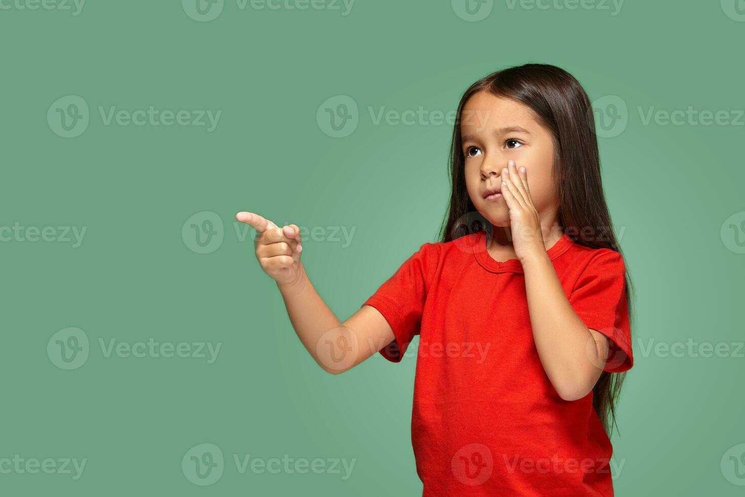 Young girl in red t-shirt is afraid of something photo