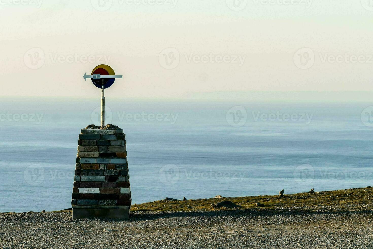 a sign on top of a mountain photo