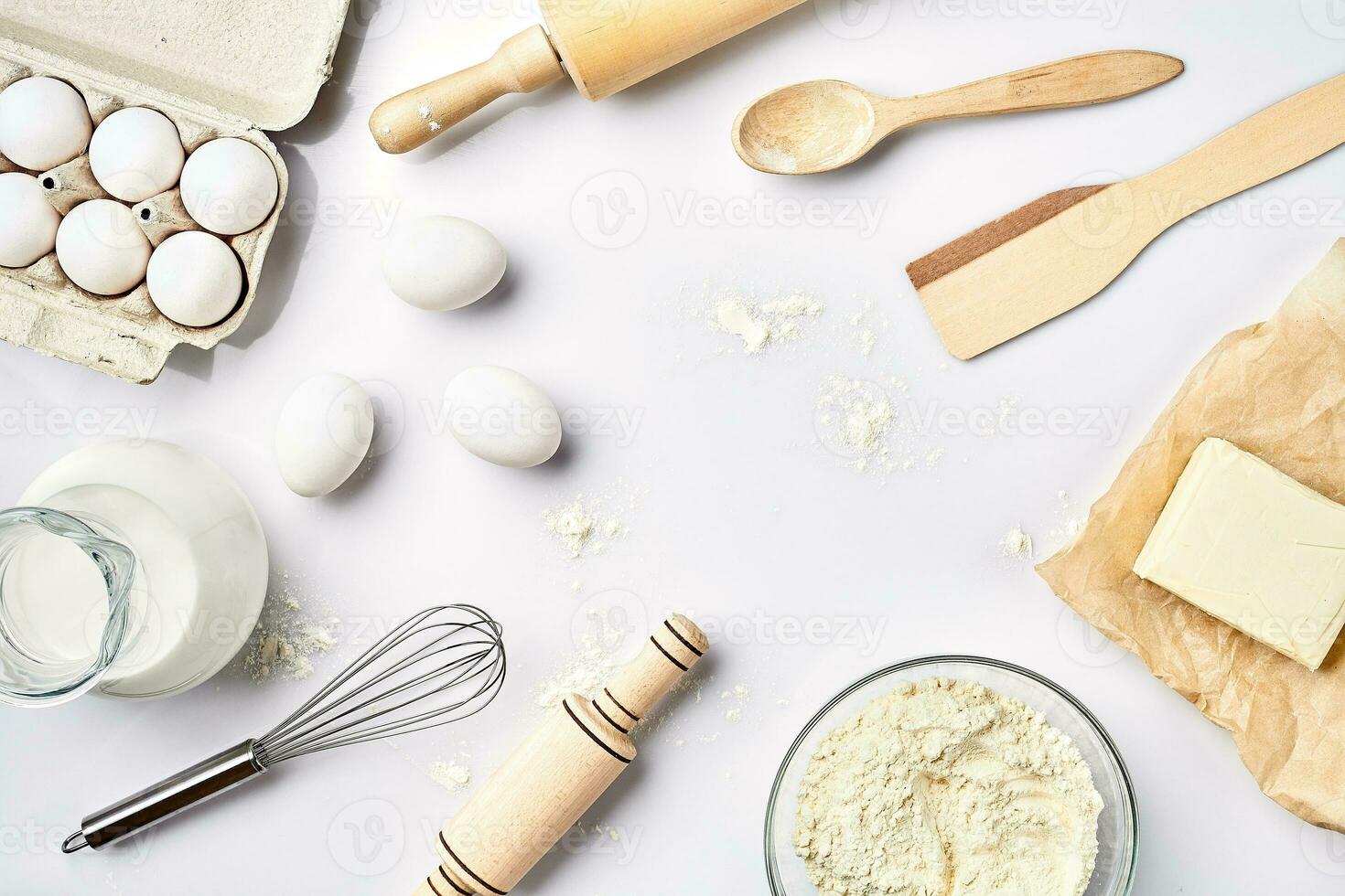 Preparation of the dough. A measurement of the amount of ingredients in the recipe. Ingredients for the dough flour, eggs, rolling pin, whisk, milk, butter, cream. Top view, space for text photo