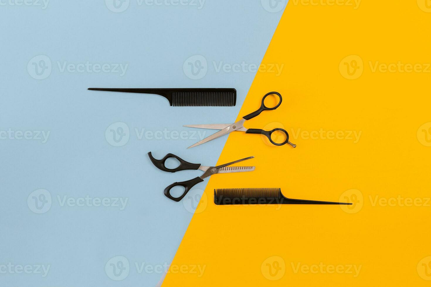 Hairdresser set with various accessories on orange and blue background photo