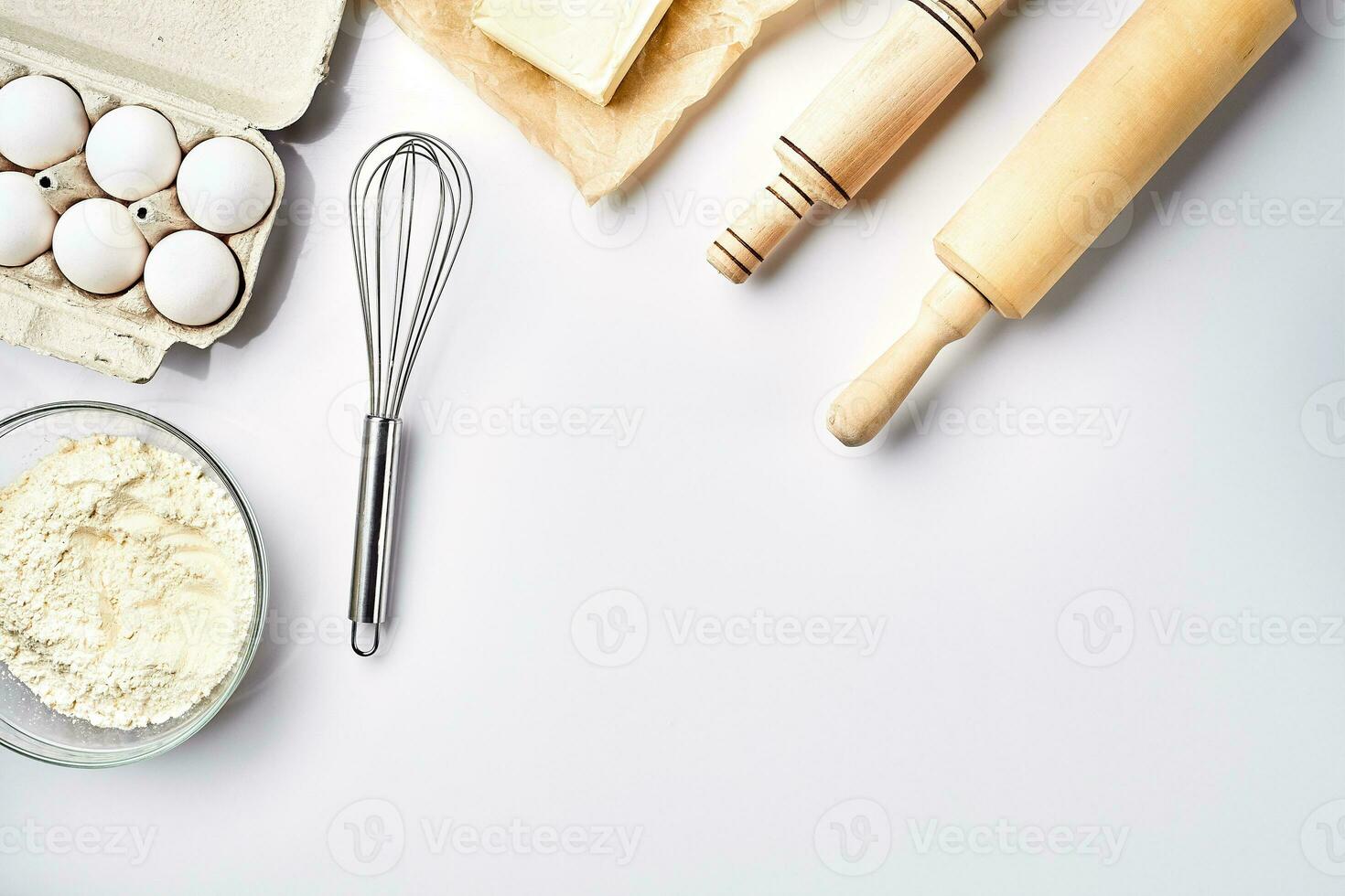 Preparation of the dough. Ingredients for the dough - flour, butter, eggs and various tools. On white background. Free space for text . Top view photo
