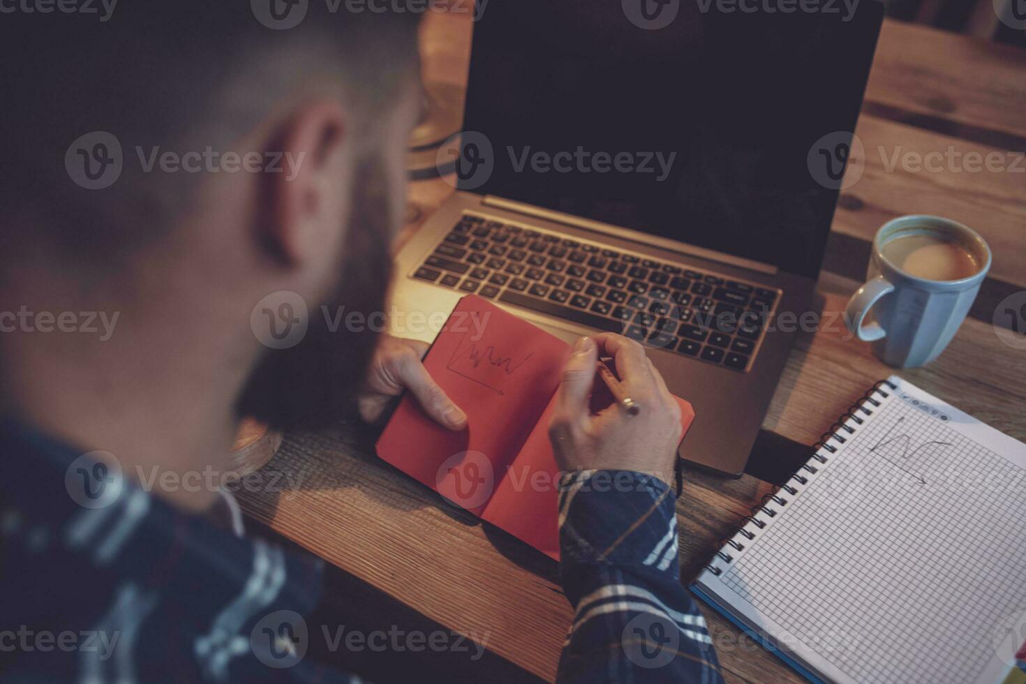 Cropped image of young man chatting via net-book during work bre photo