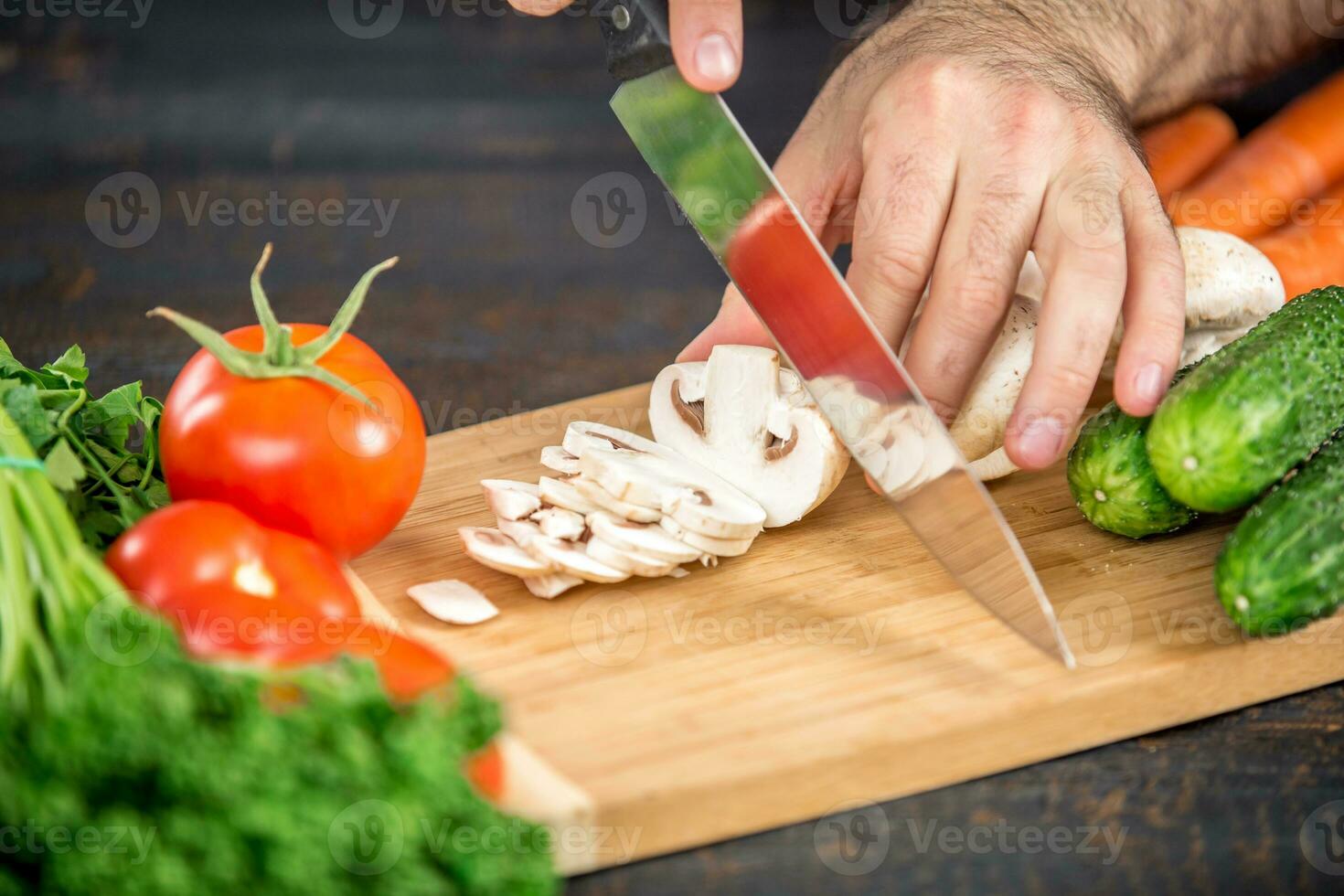 Male hands cutting vegetables for salad photo