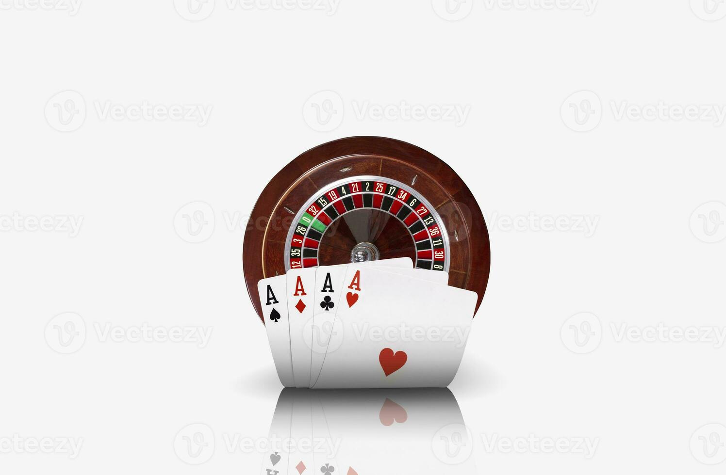 Close-up photo of four aces standing ahead of a brown roulette, isolated on white background. Playing cards. Gambling entertainment.