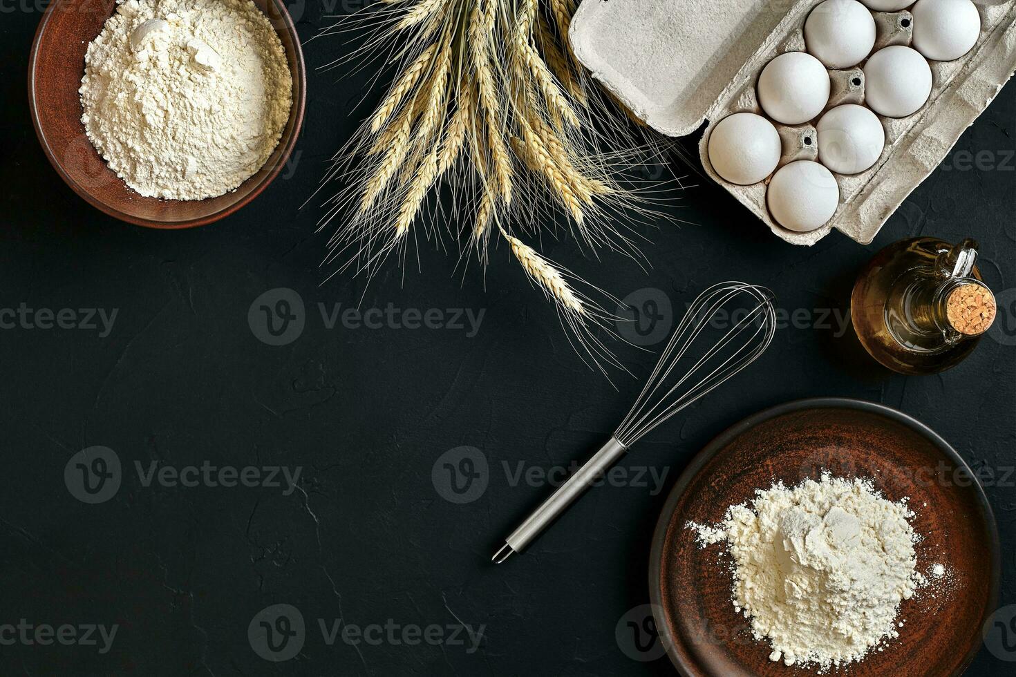 Preparation cooking baking kitchen table brown dishes ware fresh grocery different ingredients eggs, flour, oil, stuff top view photo