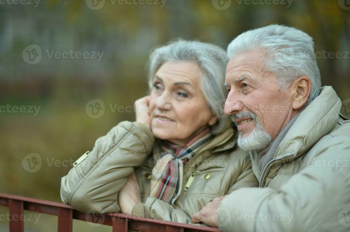 Elderly couple dance in the park in autumn. photo