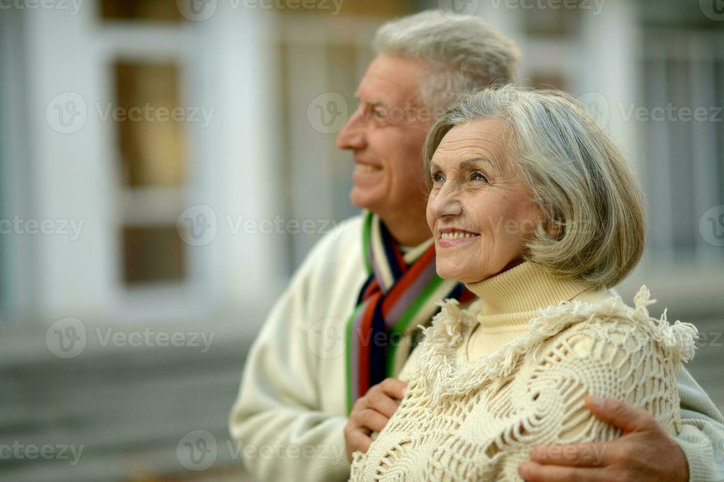 Close up portrait of beautiful senior couple relaxing in park photo