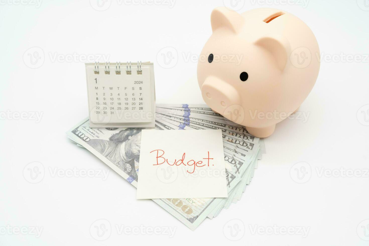 BUDGET text on paper, Piggy bank, US dollars with 2024 JAN calendar on a white background. Finance, money management concept. photo