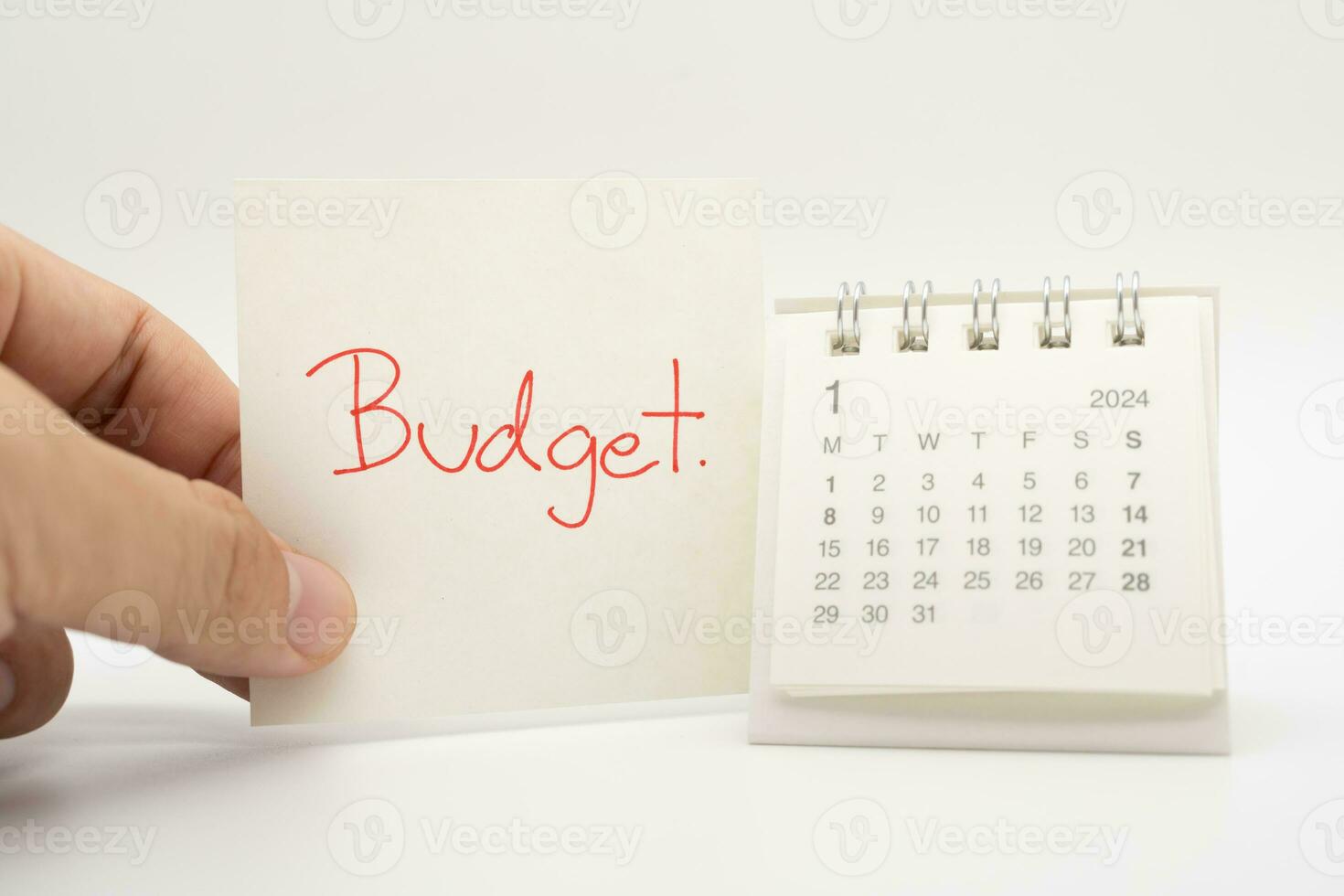 BUDGET text on paper with 2024 JAN calendar on a white background. Finance, money management concept. photo