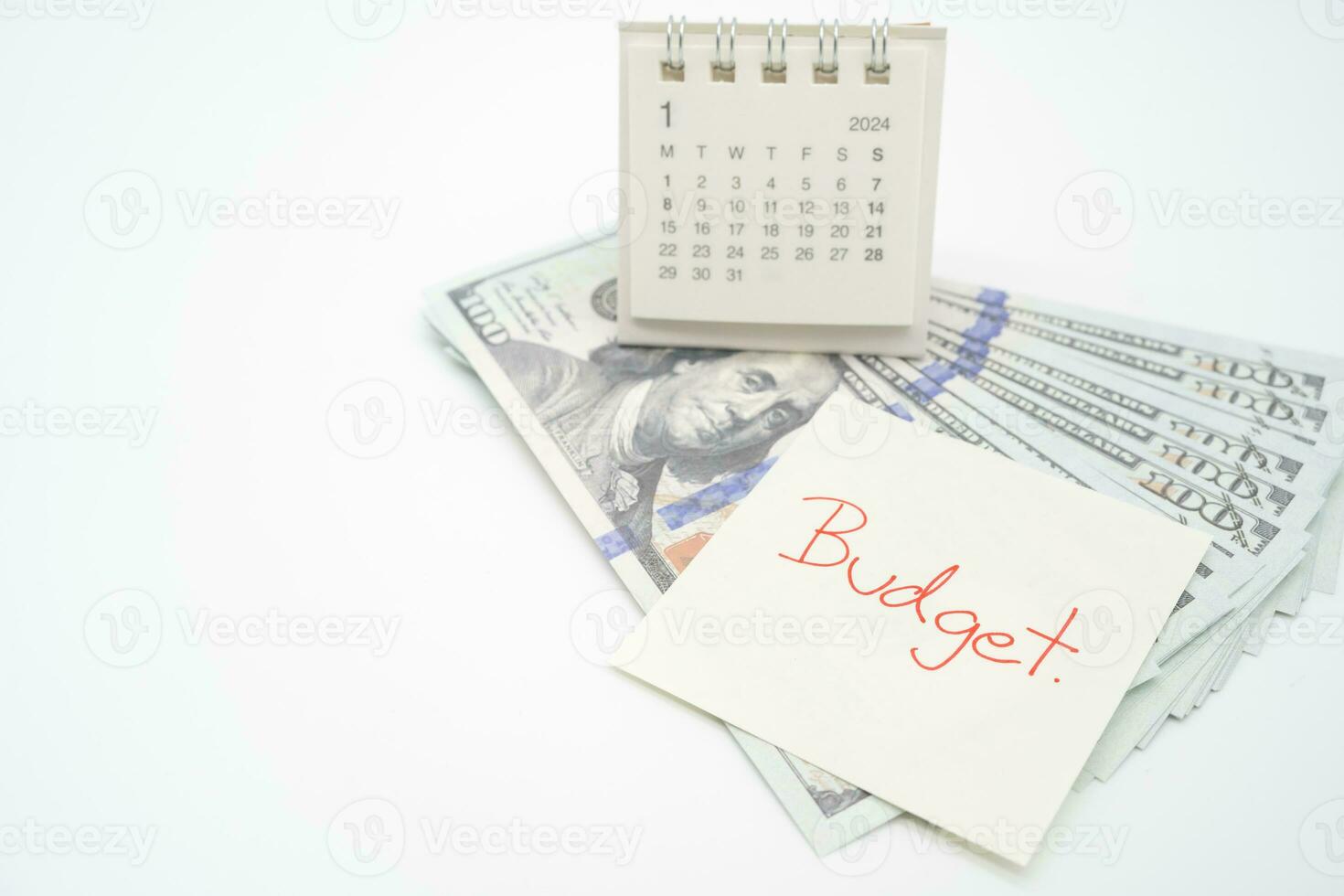 BUDGET text on paper, US dollar with 2024 JAN calendar on a white background. Finance, money management concept. photo