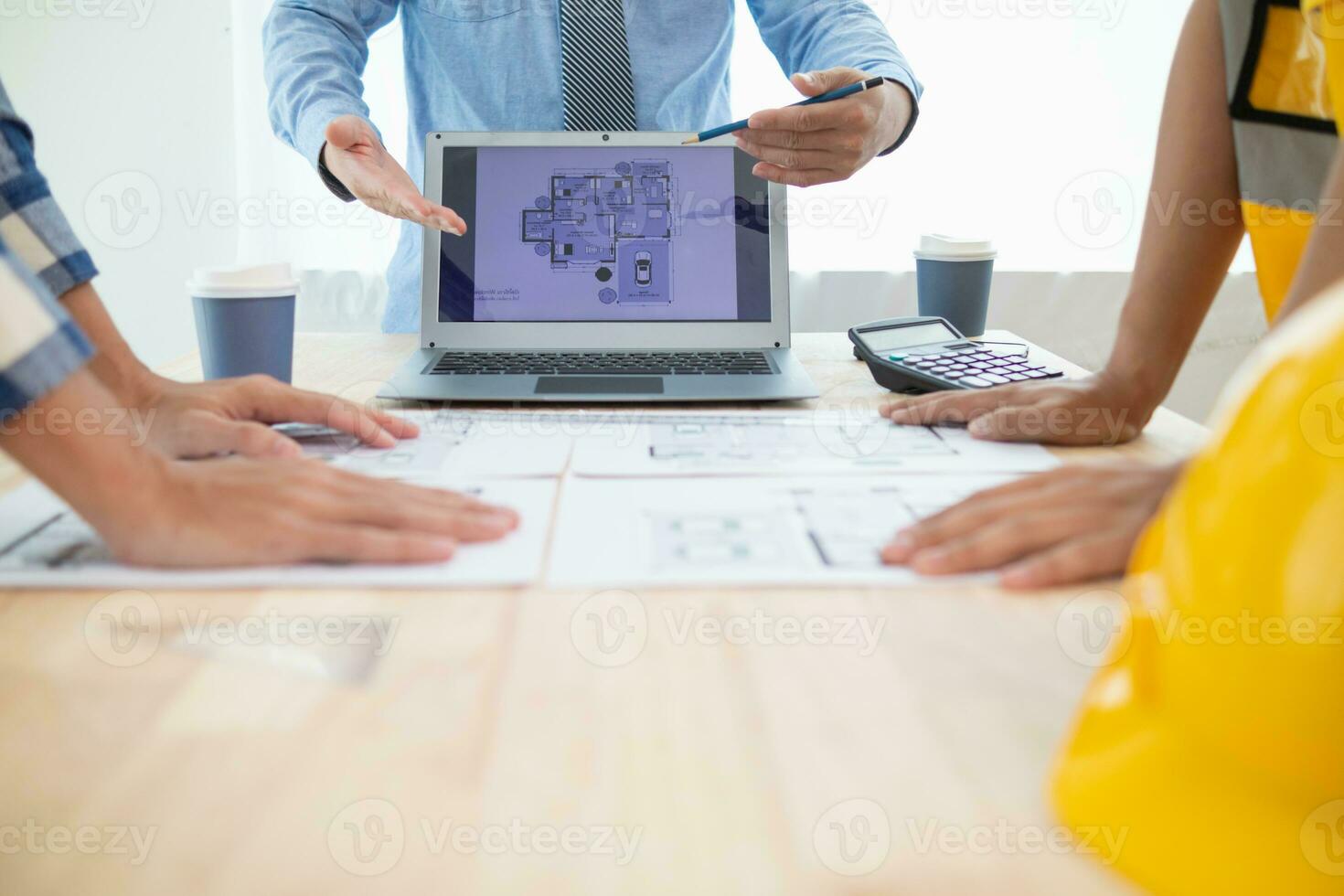 Construction engineers discuss and exchange ideas with architects to improve house plans to meet customer needs. A concept for exchange of design ideas between construction engineers and architects. photo