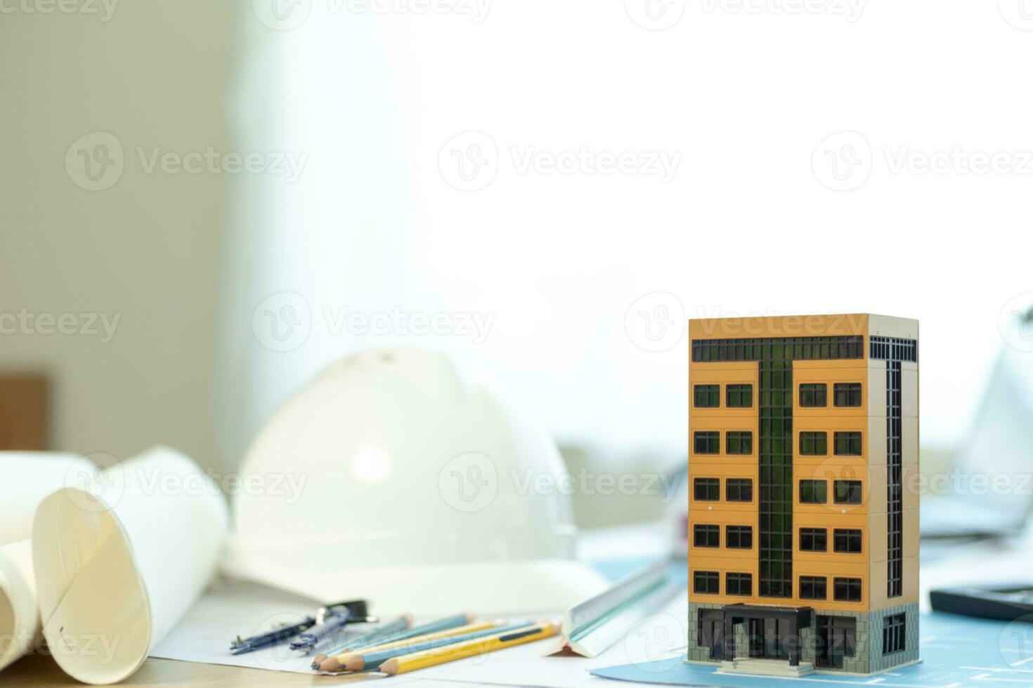 Building models and blueprints are placed on work desks in the construction engineering team offices to plan construction to achieve their goals and to simulate building models for clients to see. photo