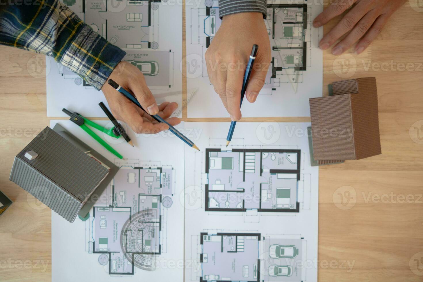 Construction engineers discuss and exchange ideas with architects to improve house plans to meet customer needs. A concept for exchange of design ideas between construction engineers and architects. photo